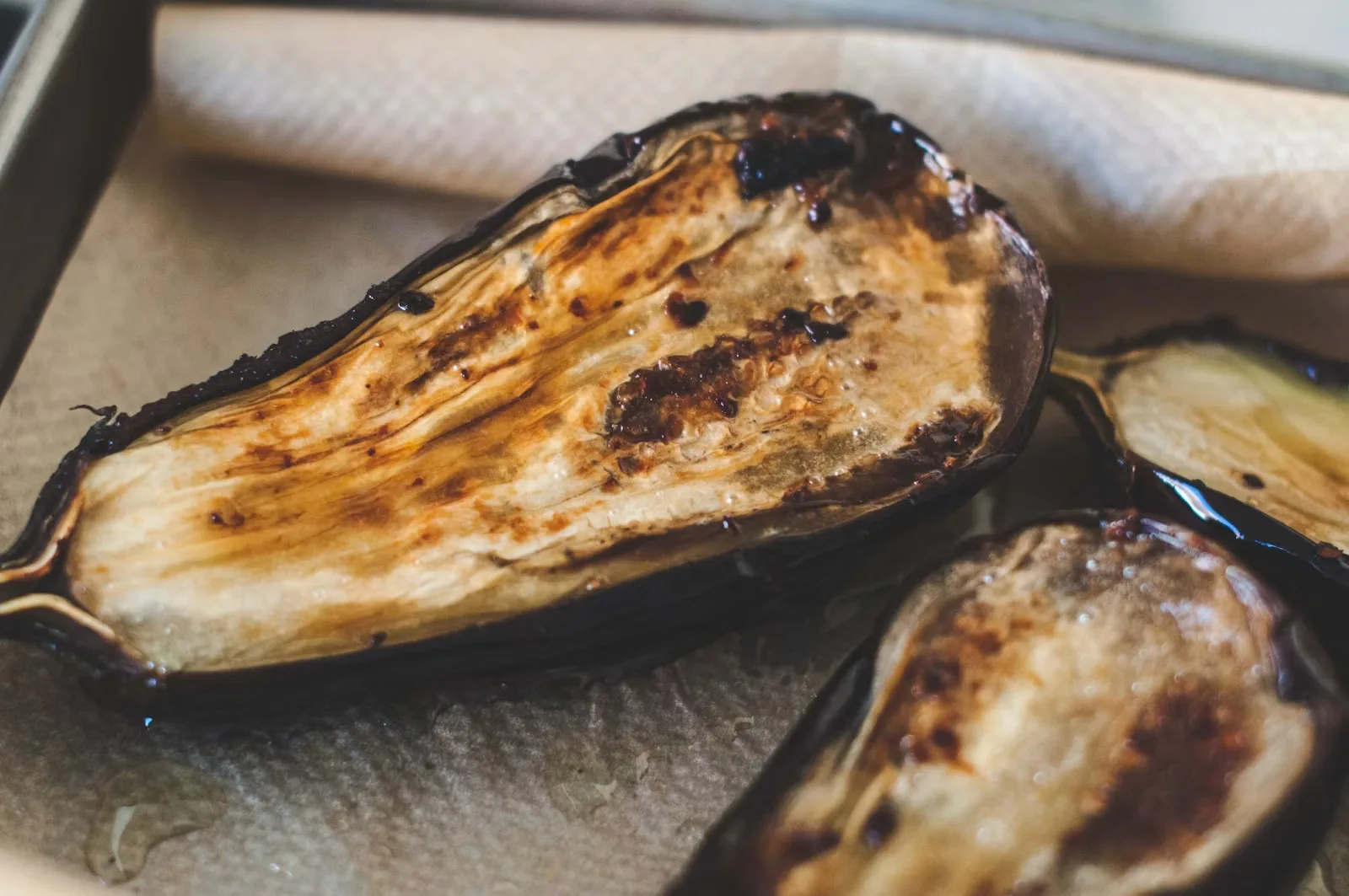 Aubergine halves roasted to a golden crust