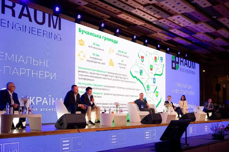 A slide about the Bucha community on the conference hall screen