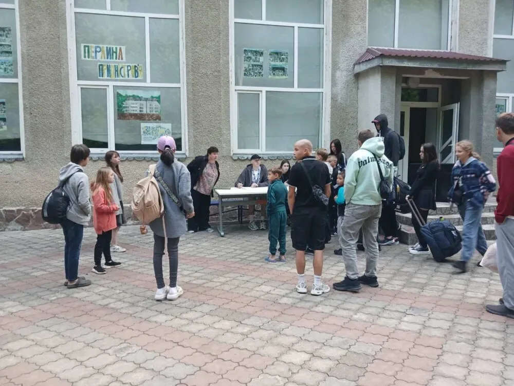 Children from the Borodianka community registering on arrival at the holiday centre