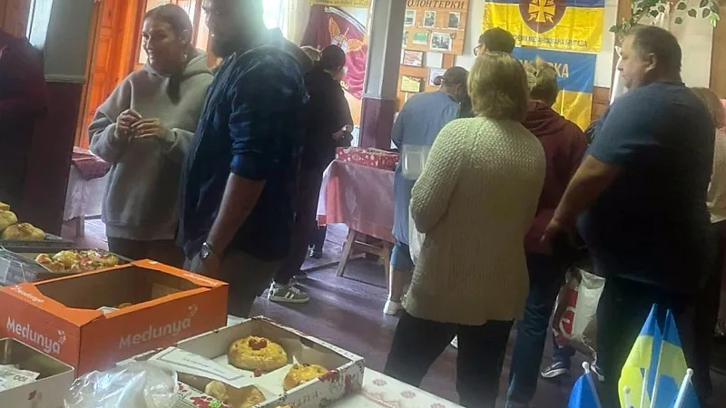 Visitors at the stalls in the Komarivka community centre