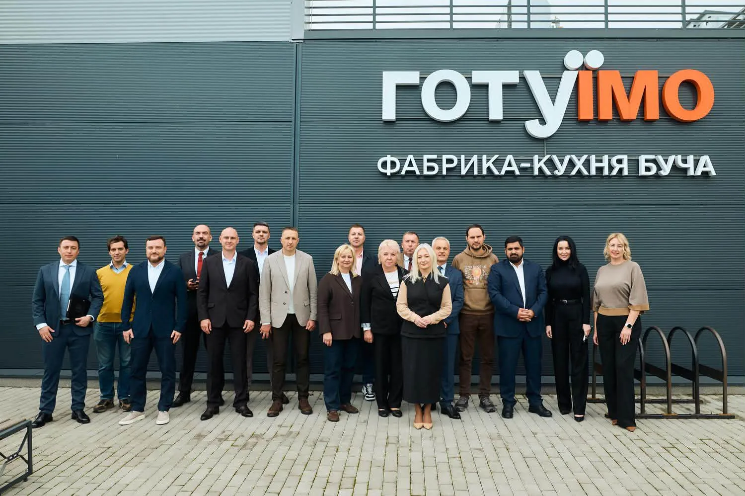 Participants of the coordination meeting outside the HotuIemo central kitchen in Bucha, 25 September