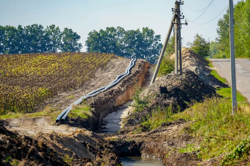 Open photo full screen Water main pipes laid along the road