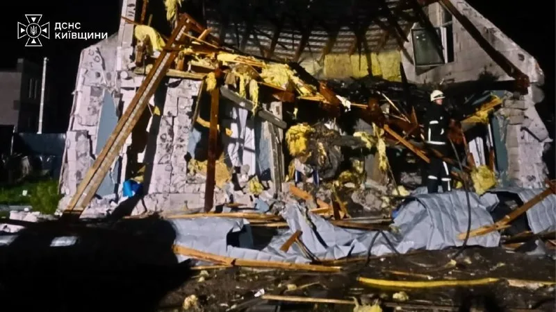 A rescuer at the ruined house in Bucha district, night of 29 September