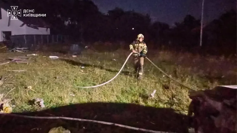 A rescuer putting out what is left of the fire