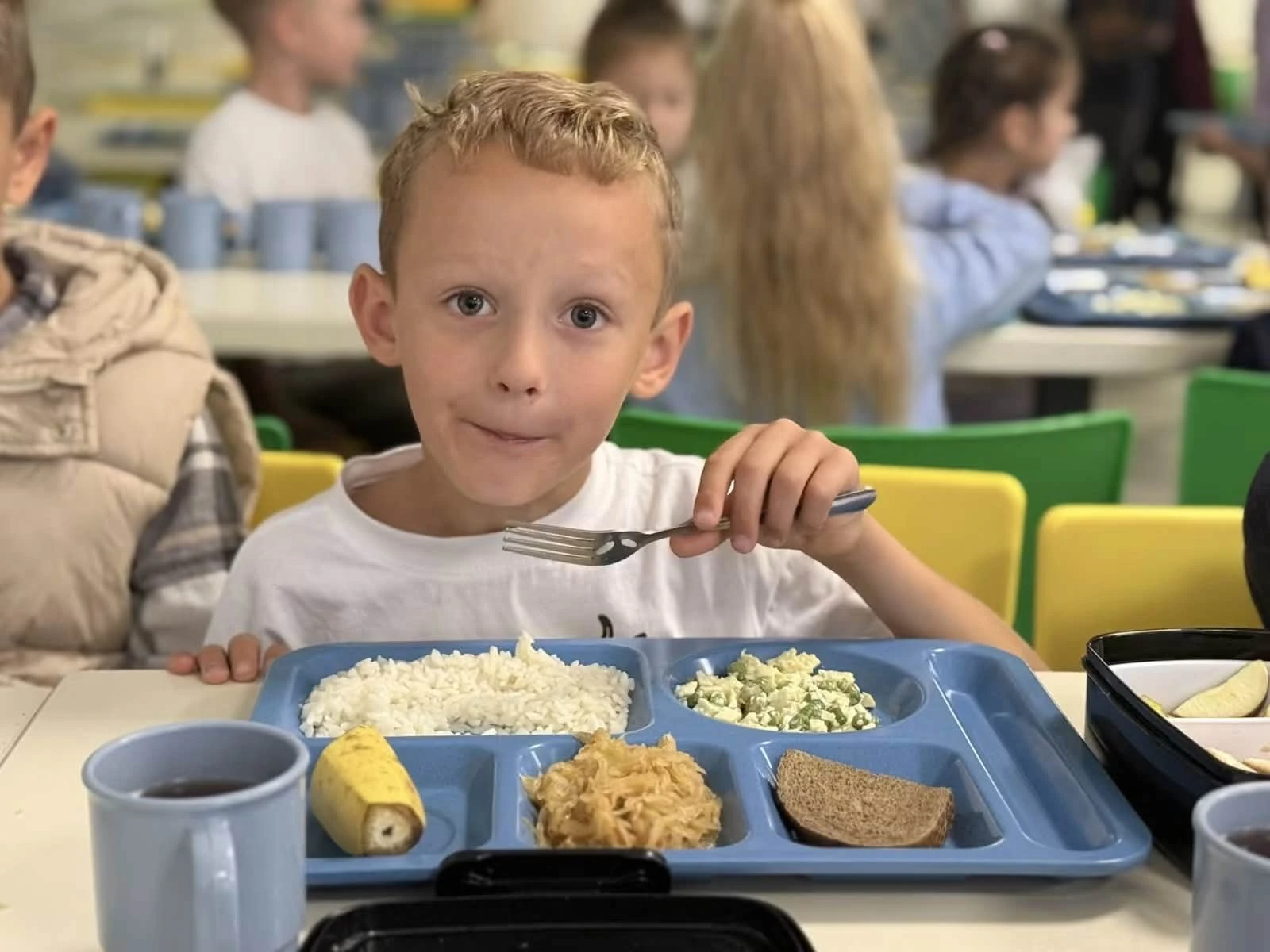A pupil with lunch in a school canteen in the Bucha community