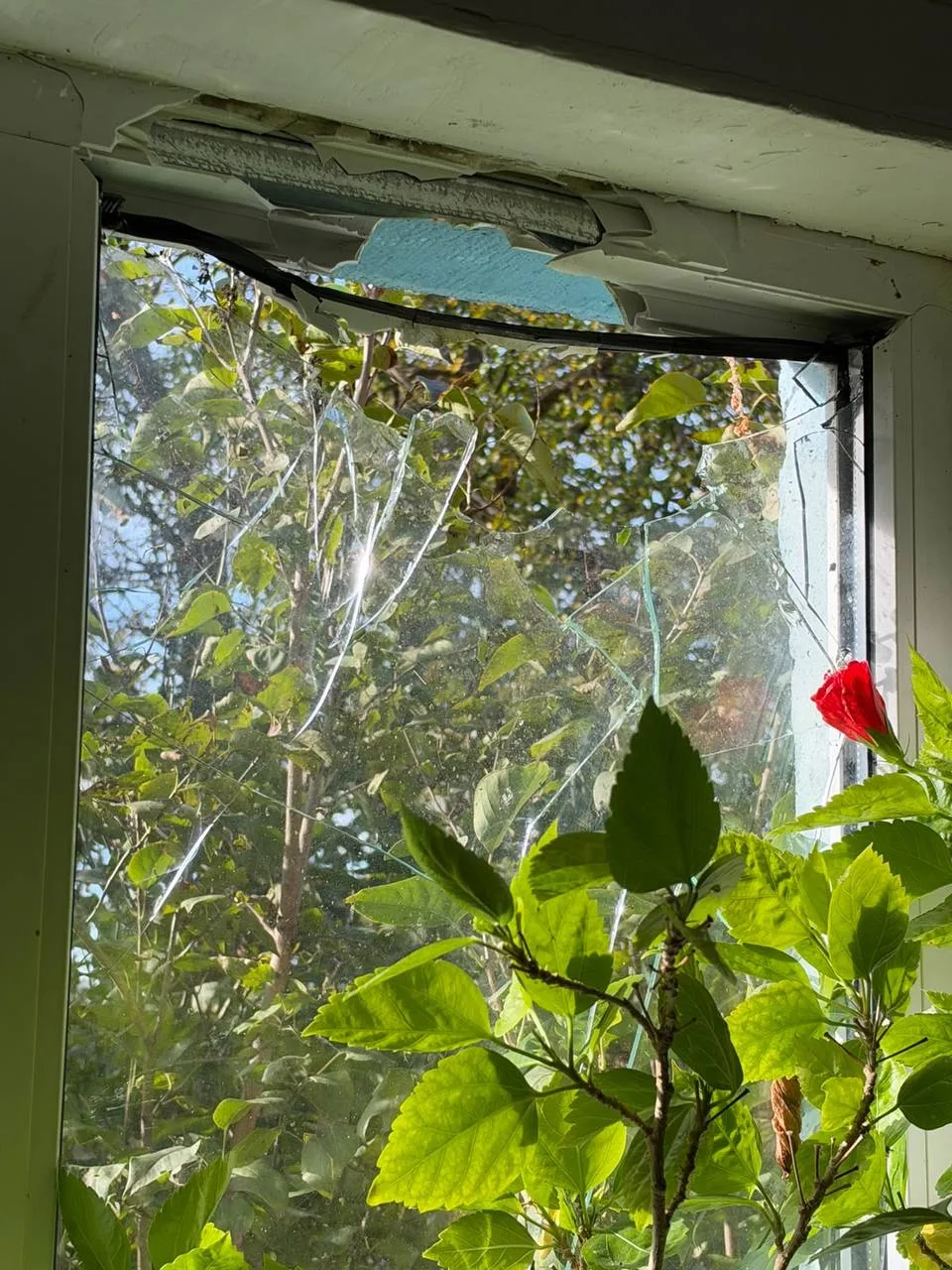 A broken window in a damaged house in Chervone
