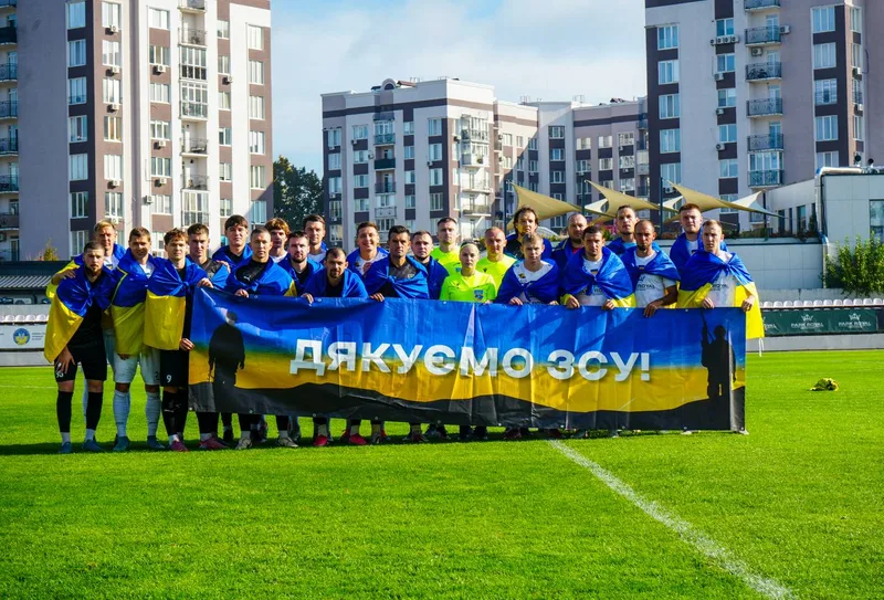 Players with a “Thank you, Armed Forces!” banner before the Ukrainian Amateur Cup quarter-final, 14 October 2026