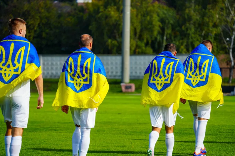 Players with Ukrainian flags at Yuvileinyi's anniversary