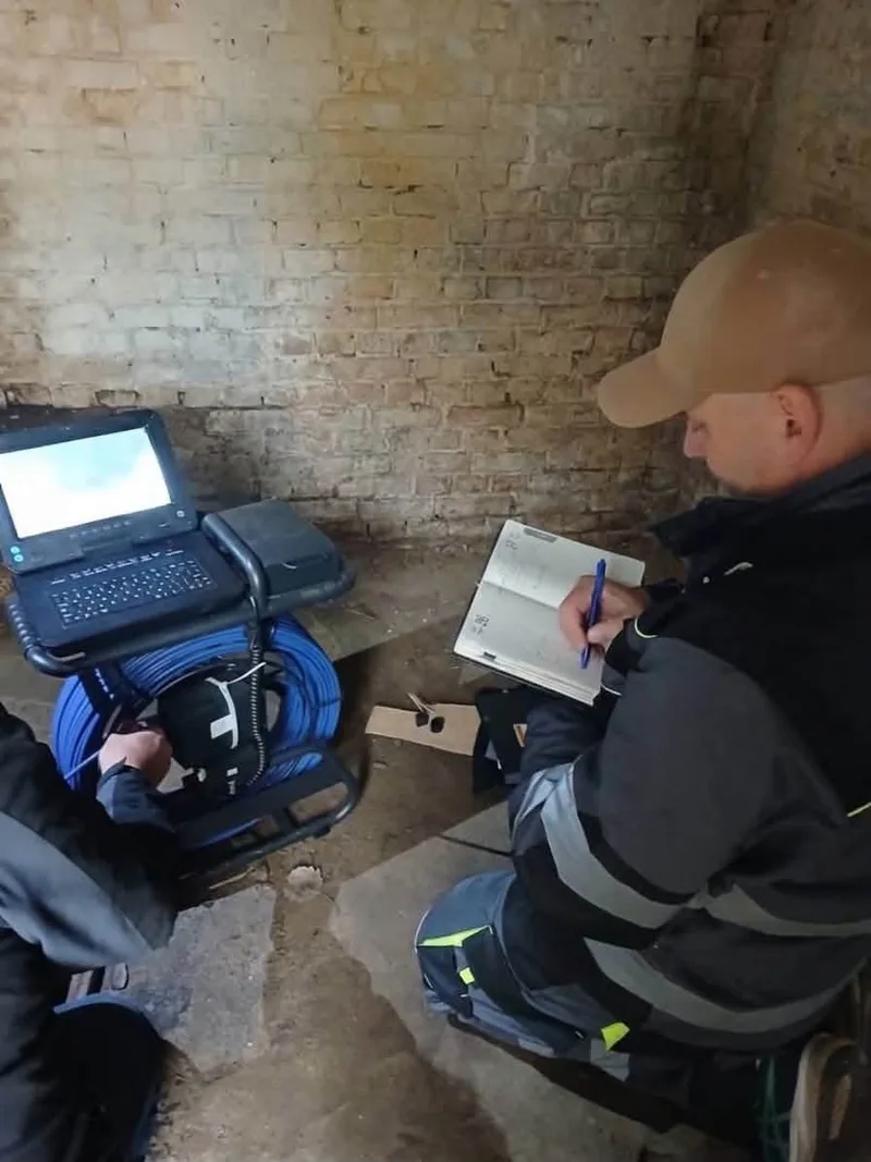 A specialist recording the inspection results